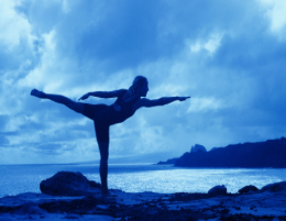 Person balancing near the ocean